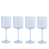 Four ribbed glass goblets on a white background